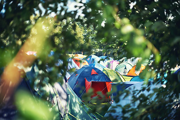 Image showing Many tents, camping and outdoor in nature for a music festival. Row of rainbow marquees placed on ground at musical soiree, entertainment event and carnival celebration, relax on holiday campsite