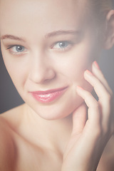 Image showing Skincare, hand and portrait of woman in makeup to glow isolated on a dark studio background. Face, touch and beauty of young model in cosmetics, manicure and spa facial treatment for smooth skin