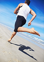 Image showing Man, running and water at beach with fitness, sport and training for marathon by the sea. Workout, exercise and back of athlete with health and wellness outdoor of runner with cardio in summer