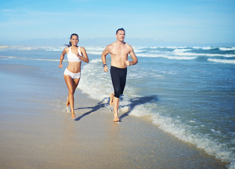 Image showing Running, beach and couple with fitness, cardio and weekend break with sunshine and training for health. Runners, seaside and man with woman or workout with practice and activity for wellness or hobby