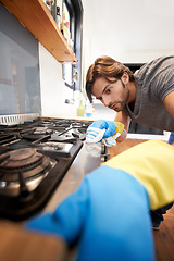 Image showing Man, kitchen and cleaning a countertop with cloth, spring clean and polishing for hygiene at home. House, responsibility and routine to remove dirty stains, germs with water and soap for fresh space