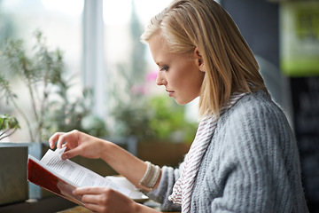 Image showing Coffee shop, relax and woman with book reading by window with drink, cappuccino and latte. Cafeteria, restaurant and happy person with story, literature and novel for knowledge, learning and hobby