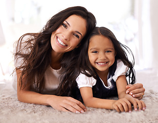 Image showing Happy mother, portrait and child lying on floor in relax for bonding, love or care together at home. Face of mom, parent and little girl, daughter or kid with smile in living room for family time