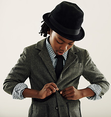 Image showing Black child, suit and fashion in studio for vintage style and confidence on a white background. Retro kid or boy check his clothes, coat and fedora hat for fancy character, cosplay and formal