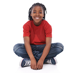 Image showing Boy, child and portrait, smile in studio with casual clothes for fashion, positive mood and childhood on white background. T-shirt, jeans and simple outfit, African kid or youth sitting down