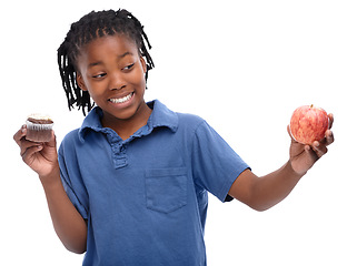 Image showing Kid, apple and cupcake in studio with smile for thinking, contemplating and decision on snack. Black child, happy and unsure with choosing for lifestyle, fruit or sweet dessert on white background