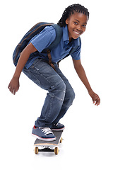 Image showing Skateboard, student or portrait of African kid in studio with smile, skill or trick with bag or cool style. Skater, performance or happy child skateboarding with energy isolated on white background