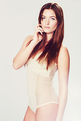 Image showing Woman, portrait and confidence with lingerie in studio for body positivity, sexy and attitude on white background. Model, person and underwear with red hair, pride and femininity for wellness