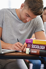 Image showing Student at a desk, man and writing with textbooks, education and knowledge with exams and test. Person, college and guy with ideas and laptop with inspiration and studying with learning or university