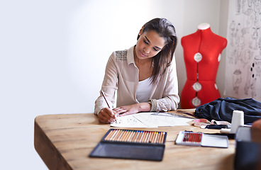 Image showing Fashion designer, woman and drawing on paper with pencil in startup office of small business. Creative, person or tailor sketch at desk for project, planning or writing draft of ideas for clothes