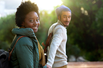 Image showing Holding hands, park and happy interracial couple together with smile, bag and morning commute to university. College, students and romance in nature, man and woman with diversity, mockup and love.