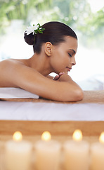 Image showing Relax, massage and woman at spa for skincare, peace and calm at table with candles for aromatherapy. Beauty, therapy and person at salon to pamper healthy body, treatment and wellness for luxury