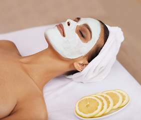 Image showing Woman, face mask and cosmetology for skincare in spa, detox and cosmetic treatment for lemon facial. Person, relax and beauty with natural clay on skin, soothing and vitamin c for dermatology on bed