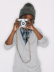 Image showing Photographer, portrait or child in studio with camera isolated on white background for creative talent. Photography, African boy or cool kid artist with hobby, style or picture ready for photoshoot