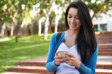 Image showing College, woman and typing outdoor with phone for social media and walking with communication on campus. Online, chat and girl with virtual contact on smartphone, connection and networking in Paris