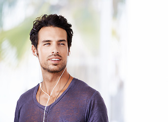 Image showing Man, thinking and smile with earphones for idea, podcast or streaming online on mockup. Male person, happy and confident with listening to music on headphones for enjoyment, fun and wellness