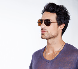 Image showing Serious, fashion and man with sunglasses in studio with confidence, cool style and pride. Calm, person and face with shades in casual outfit for vacation in white background and relax in mock up