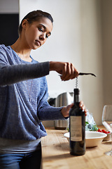 Image showing Woman, open wine and bottle for dinner, evening meal with corkscrew and preparing to drink for enjoyment and nutrition. Alcoholic beverage, tools or equipment with cooking for dining in kitchen