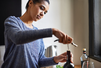 Image showing Woman, opening wine and bottle for dinner, evening meal with corkscrew and preparing to drink for enjoyment and nutrition. Alcoholic beverage, tools or equipment with cooking for dining in kitchen