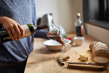 Image showing Hands, pouring red wine and home for dinner, relax for peace and person with drink in kitchen. Alcohol, glass and bottle with refreshment, hydration with beverage and read to chill in apartment