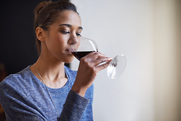 Image showing Woman, drinking red wine and home to relax for peace and leisure with alcoholic liquid in kitchen. Tasting alcohol, glass and refreshment, hydration with beverage to celebrate or chill in apartment