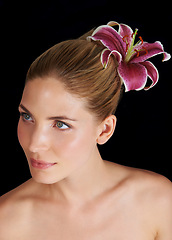 Image showing Hair, flower and beauty of woman, thinking and skincare isolated on a black studio background. Natural, floral makeup and hairstyle of model in cosmetics, salon and lily for organic facial treatment