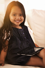 Image showing Portrait, happy and little girl with tablet on sofa for entertainment, elearning or social media at home. Face of female person, child or kid with smile, technology or ebook in living room at house