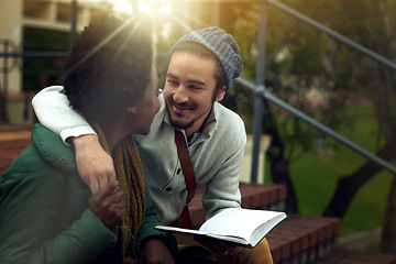 Image showing Book, study and interracial couple together on campus with hug, bag and morning romance at university. College, students and love on steps, man and woman with diversity, education and happy embrace.