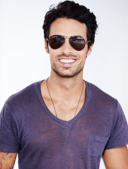 Image showing Happy, portrait and man with fashion in sunglasses on studio, white background with confidence. Summer, holiday and person smile in casual outfit for vacation and relax in cool style with pride