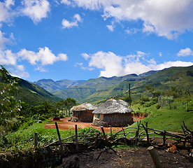 Image showing Rural, village and hut in landscape with mountains, nature and summer in countryside of Africa. Cottage, home and travel to remote cabin in bush, field or outdoor in natural environment with houses