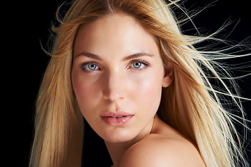 Image showing Beauty, hair and serious portrait of woman with wind, straight hairstyle or keratin treatment isolated in dark studio. Salon styling, growth and face of girl with healthy haircare on black background