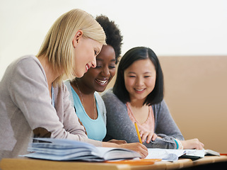 Image showing Students, university and study group for research in classroom, information and notes. People, books and support in education for learning, problem solving and ideas for solution and diversity