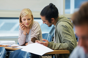 Image showing Discussion, university and students in classroom for studying with text book for test or exam. Conversation, writing and young people working on college assignment together in lecture hall at academy