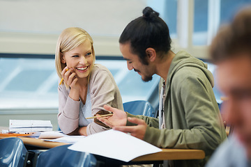 Image showing Conversation, college and students in classroom for studying with text book for test or exam. Discussion, writing and young friends work on university assignment together in lecture hall at academy.