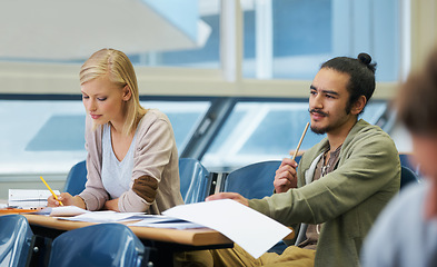 Image showing Lecture, university and students in classroom for studying with text book for test or exam. Education, scholarship and young friends learning write for college assignment together in hall at academy.