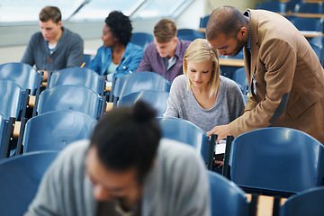 Image showing Education, university and professor with student in class for learning, teaching or lecture. College, school or development with teacher and pupil in classroom at desk for growth, support or study