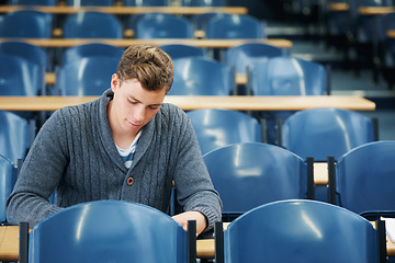 Image showing Lecture hall, thinking and man with university, student and college with exam and education. Person, writing and guy in classroom with test and learning with studying and creativity with knowledge