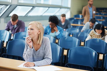 Image showing Woman, student and exam in classroom with thinking for idea, knowledge and assessment at campus. Female person, planning and sitting with paper for brainstorming, education and growth in university