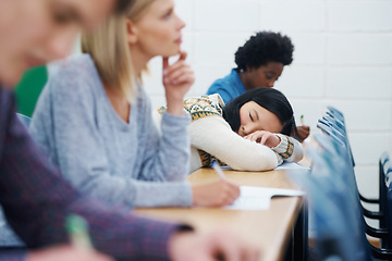 Image showing Student, university and sleeping on desk in classroom for boring lecture or burnout, fatigue or scholarship. People, college and diversity with research paper in USA for learning, knowledge or tired