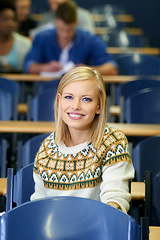 Image showing University student, portrait and smile at desk in lecture hall in London for english class. education or scholarship. Female person, face and academy for teaching or learning course, lesson or exam