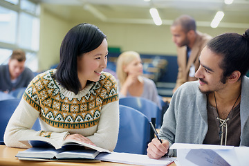 Image showing Talking, university and students in classroom for studying with text book for test or exam. Discussion, writing and young people working on college assignment together in lecture hall at academy.