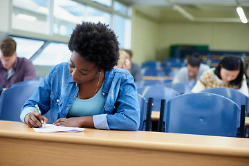 Image showing Writing, college and black woman student in classroom studying for test, exam or assignment. Education, university and African female person working on project with knowledge in lecture hall.