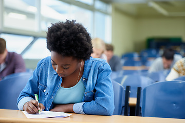 Image showing Writing, university and black woman student in classroom studying for test, exam or assignment. Education, college and female person working on project with knowledge in lecture hall for learning.