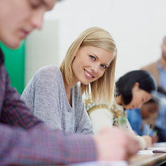 Image showing Portrait, students and woman in college, smile and university with learning and knowledge. Face, exam and girl writing and books with academy with creativity and happy in a classroom or scholarship