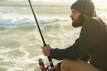 Image showing Man, thinking and fishing by ocean in relax, nature and fish recreation for wellness on vacation. Fisherman, waiting and holiday in cape town by beach, adventure and summer by rod for travel to bite