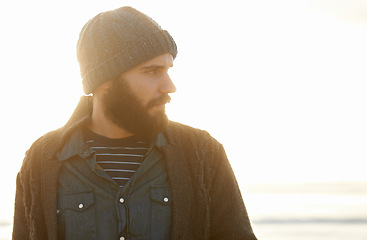 Image showing Man, nature and winter fashion by beach for cold, comfort and protection in cape town weather climate. English guy, thinking and trendy clothes of scarf, beanie and idea by overcast ocean in morning