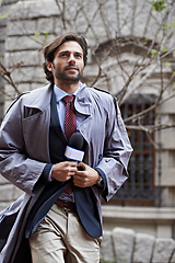 Image showing Man, news and reporter with microphone outdoor as press for media coverage and looking up to think for questions. Anchor, interviews and ready for live reporting and broadcasting for television.