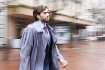 Image showing Businessman, hurry and street in city for work in corporate company, late for meeting and overcoat. Executive, outdoor and rush in town in blur to be professional for New York office and stress