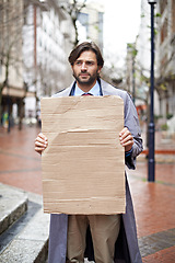 Image showing Sad, business and man with poster, unemployed in city and professional with stress and anxiety. Person, outdoor and financial criss with worker and stock market crash with job loss with recession