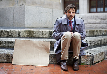 Image showing Homeless, business or man with cardboard, unemployed in city or professional with recession or begging. Person, outdoor or financial criss with worker or stock market crash with job loss with poverty